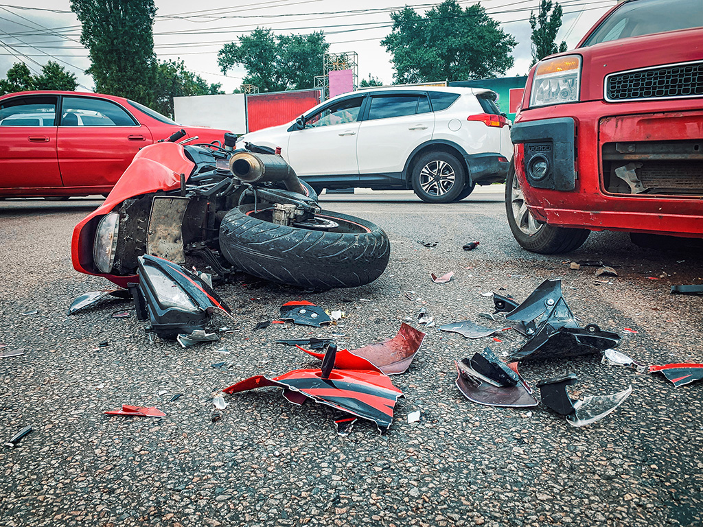 Red motorcycle turned over after motor vehicle colision